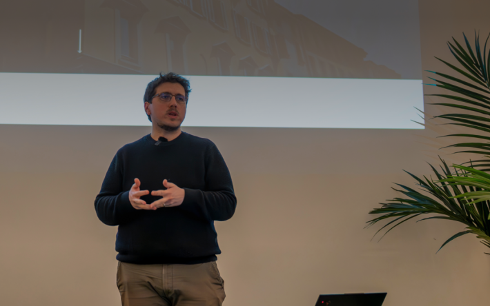 Speaker presenting at PoW.space Lugano workshop on AI and business, sharing insights on artificial intelligence applications for business innovation.